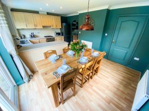 a kitchen and dining room with a wooden table and chairs at Kings Quarters Boutique Rooms in Hartford