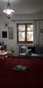 a bedroom with a large bed with a red blanket at L'arancio Antico in Iglesias