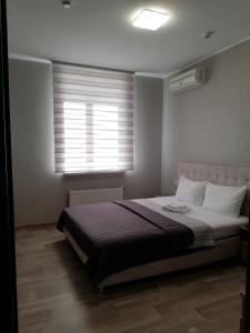 Postel nebo postele na pokoji v ubytování Prometey Hotel
