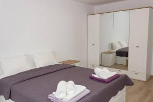 a bedroom with a bed with white towels and a mirror at Perfect Summer Vacation Rental - One-Bedroom Flat in Topola
