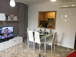 a dining room with a table and chairs and a tv at RUIDERA HOLIDAY in Ruidera