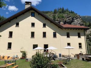 a large building with tables and umbrellas in front of it at Dazio Grande B&B in Rodi