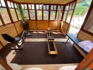 an empty room with a gym with equipment in it at Hôtel Restaurant Le Chalet d'Auron et Spa Inclus in Auron