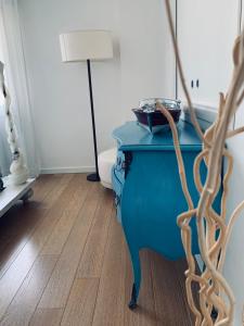 a blue table in a room with a lamp at Heron apartments in Lido di Jesolo