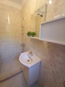 a bathroom with a white sink and a mirror at House Pierro in Orasac +18 photos