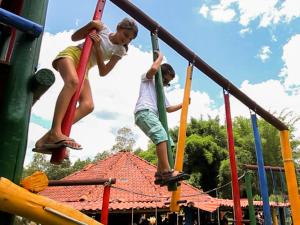 two young boys are playing on a playground at Ganso Complexo de Lazer in Lambari