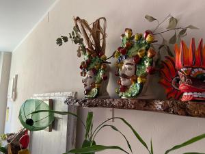un estante con tres jarrones encima de una pared en B&B Camilla, en Montecosaro