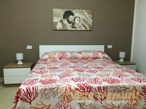 sypialnia z łóżkiem i zdjęciem na ścianie w obiekcie VISTA D'AMURI w mieście Sciacca