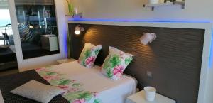 a bedroom with a bed with flowers on it at So Chic in Saint-François