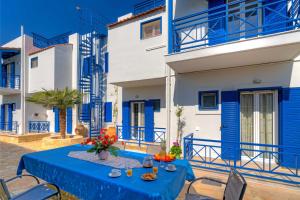 a blue table and chairs in front of a building at Heraklion Beach Hideaway Explore, Relax, Repeat-3 in Ayía Marína