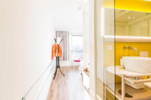 a bathroom with a sink and a mirror at Qbic Amsterdam WTC in Amsterdam +40 photos