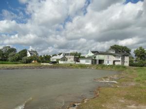 a group of houses next to a body of water at Mereääre in Haapsalu +8 photos