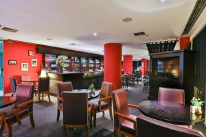 a restaurant with tables and chairs and a bar at Park Inn by Radisson Berrini in Sao Paulo