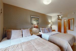 a hotel room with two beds in a room at Okemo Mountain Condo in Ludlow