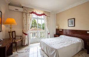 Postel nebo postele na pokoji v ubytování Hotel Hidalgo