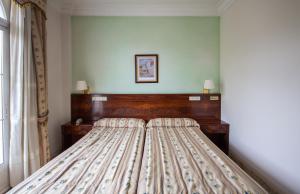 Postel nebo postele na pokoji v ubytování Hotel Hidalgo