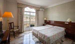 Postel nebo postele na pokoji v ubytování Hotel Hidalgo