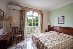 Postel nebo postele na pokoji v ubytování Hotel Hidalgo