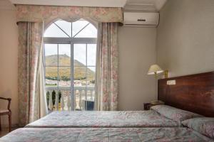 Postel nebo postele na pokoji v ubytování Hotel Hidalgo