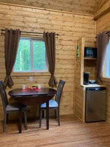 a dining room with a table and chairs in a log cabin at Golden Spot in Clearwater