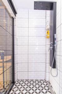 a shower stall with a black and white tile floor at STaYLE in Istanbul