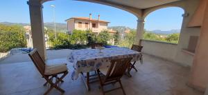 a table and chairs on a patio with a view at BEACH HOUSE Alice in Cannigione