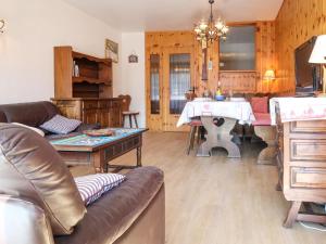a living room with a couch and a table at Apartment Bouleaux E 1 by Interhome in Nendaz
