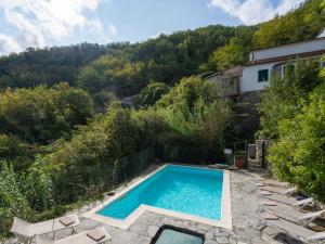 a swimming pool in a garden with a house at Apartment Appartamento 1 by Interhome in Tavole