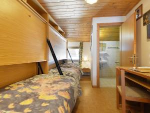 a room with two beds and a sink and a bathroom at Apartment Tieja de Gotart-4 by Interhome in Vigo di Fassa