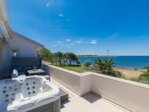 a bath tub on a balcony with a view of the ocean at Apartment Mira-5 by Interhome in Umag