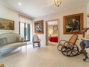a living room with furniture and paintings on the walls at Villa Can Rochet by Interhome in Alaró +59 photos