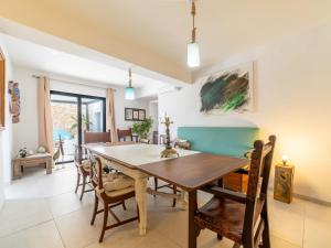 a dining room with a wooden table and chairs at Villa Can Rochet by Interhome in Alaró