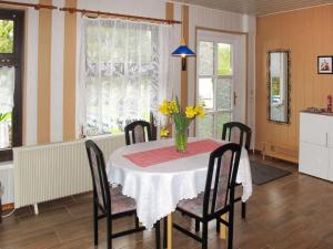 a dining room table with a vase of flowers on it at Holiday Home Siglinde by Interhome in Goldberg