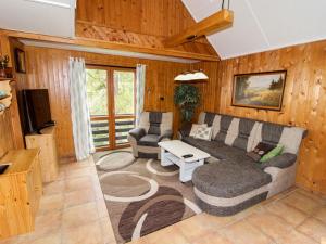 a living room with a couch and a tv at Holiday Home Kyjov u Krásné Lípy by Interhome in Kyjov