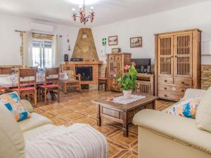 a living room with a couch and a table at Holiday Home El Viso by Interhome in Zambra