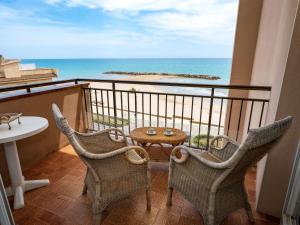 a balcony with chairs and a table and the ocean at Apartment Sun and Beach by Interhome in Cunit