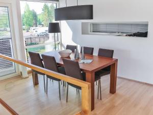 a dining room table and chairs in a room at Holiday Home Villa marina by Interhome in Padasjoki