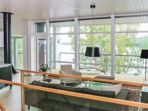 a living room with a couch and a glass table at Holiday Home Villa marina by Interhome in Padasjoki