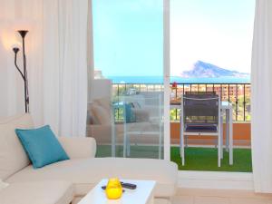 a living room with a white couch and a balcony at Apartment Residencial Jazmines by Interhome in Calpe
