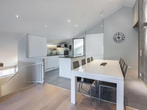 a kitchen and dining room with a white table and chairs at Holiday Home Levin stara c 15 by Interhome in Levi +15 photos