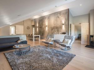 a living room with a couch and chairs and a table at Holiday Home Levin stara c 15 by Interhome in Levi