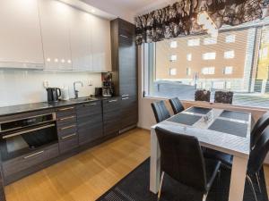 a kitchen with a table and chairs in a room at Holiday Home Tunturinlaita b3 by Interhome in Sirkka