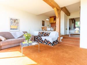 a living room with a couch and a table at Apartment La Pinchonnière-6 by Interhome in Tourgeville