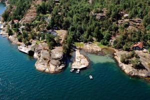 an aerial view of a cove with boats in the water at Family-Friendly Coastal Getaway Near Kragerø 3 in Kragerø +28 photos