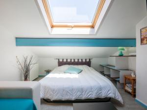 a bedroom with a bed and a skylight at Apartment Maison de l'océan-6 by Interhome in Capbreton