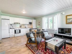 a living room with a table and a kitchen at Holiday Home Tallbacka 2 by Interhome in Bromary