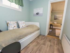 a small bedroom with a bed and a mirror at Holiday Home Tallbacka 2 by Interhome in Bromary