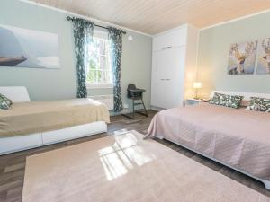 a bedroom with two beds and a window at Holiday Home Tallbacka 2 by Interhome in Bromary