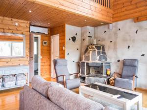 a living room with a couch and a fireplace at Holiday Home Tahkon rantatupa 7 b by Interhome in Tahkovuori