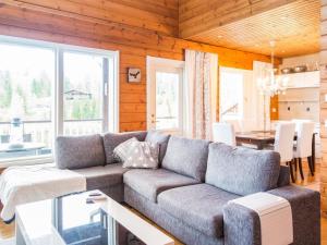 a living room with a couch and a table at Holiday Home Tahkon rantatupa 7 b by Interhome in Tahkovuori